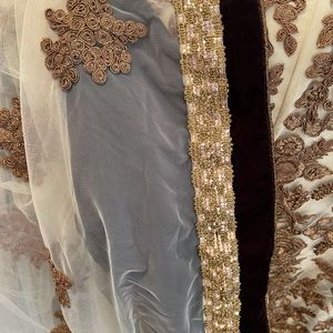 Brown Velvet with gold embroidery work on it.  Wear it once for a few hours.